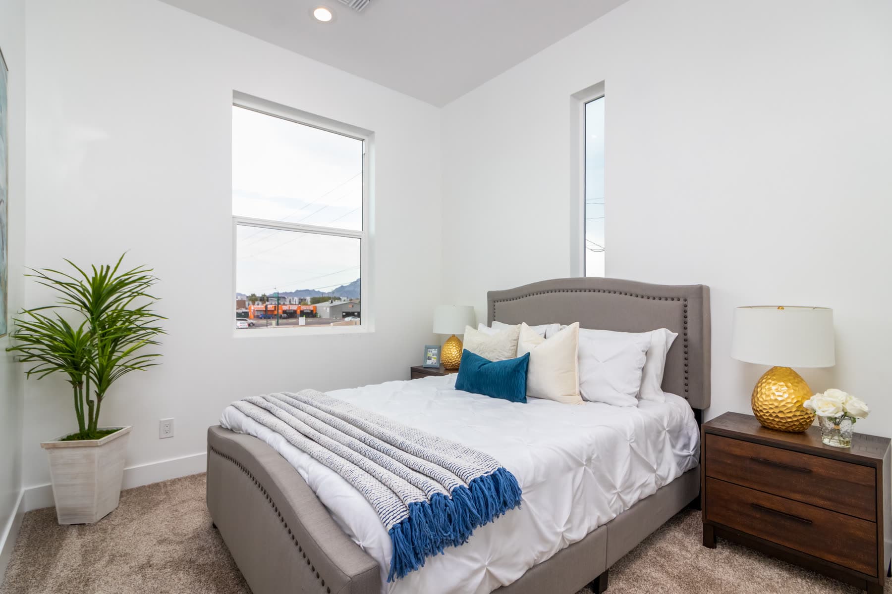 Primary bedroom with carpet and mountain-view window